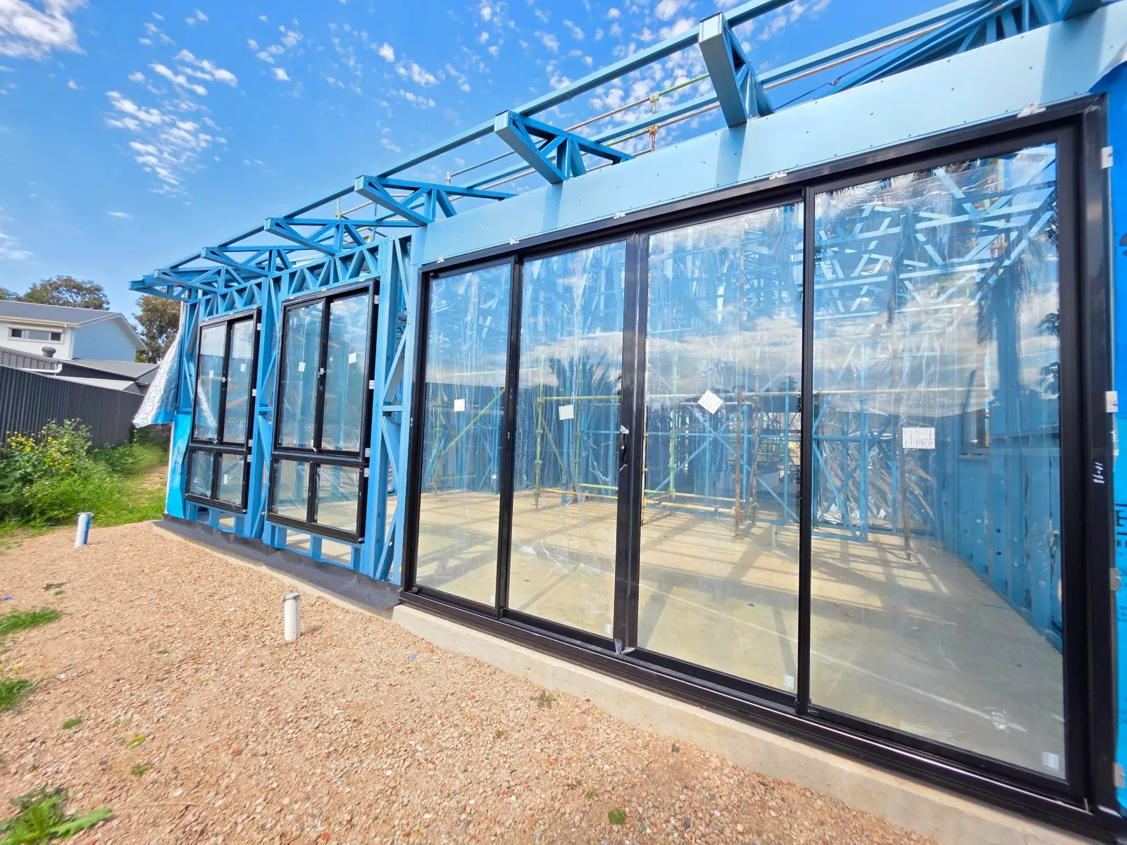 Run of aluminium glazing along the steel framed exterior of a South Australian build in progress