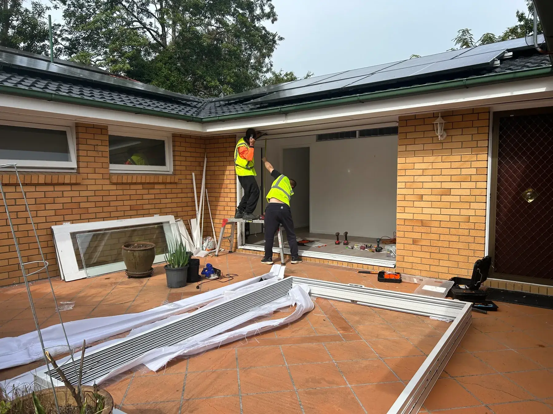 Original timber doors removed and the opening prepared for a double glazed sliding door in Kenmore QLD